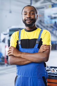 Portrait of young man standing in city