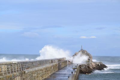 Scenic view of sea against cloudy sky