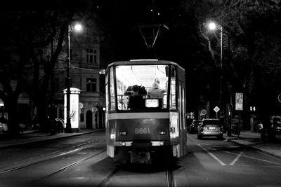 Tram on street at night