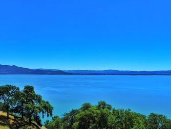 Scenic view of sea against clear blue sky