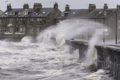 Water flowing over buildings by sea