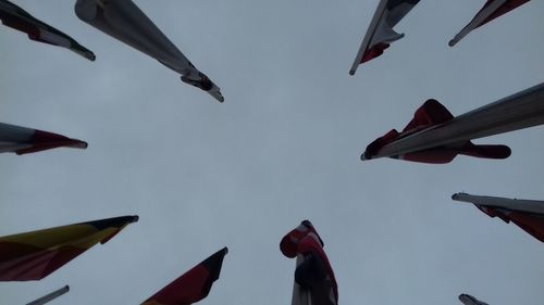 Low angle view of flags hanging against sky