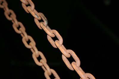 Close-up of chain against black background