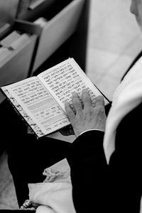 Cropped hand of woman reading book