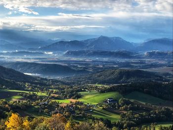 High angle view of field and mountains against sky
