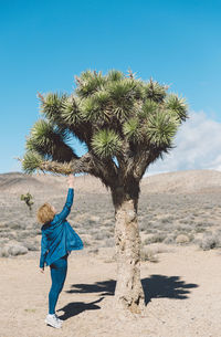 Woman touching tree