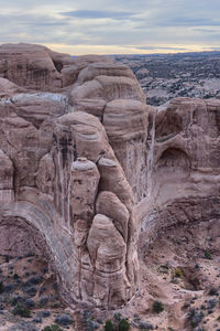 Rock formation against cloudy sky