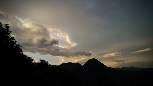 Low angle view of silhouette mountains against sky at sunset