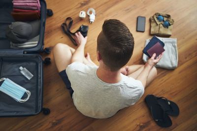 High angle view of man using mobile phone on table