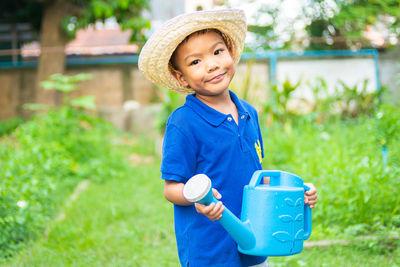 Portrait of smiling boy holding hat