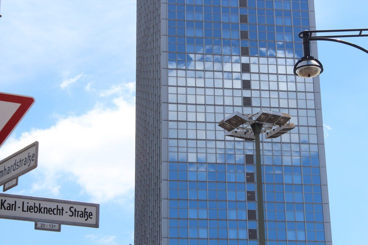 LOW ANGLE VIEW OF INFORMATION SIGN ON BUILDING AGAINST SKY