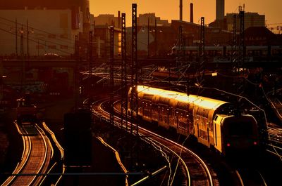 Railroad tracks in city at night