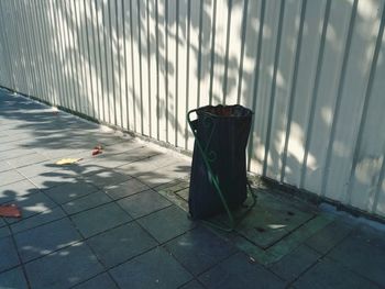 Garbage bin on footpath in city
