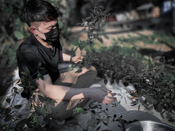 Young man and leaves on tree