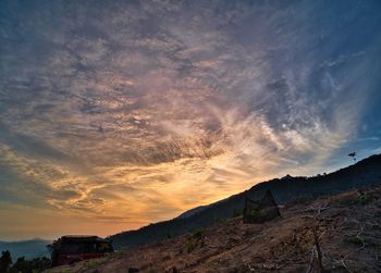 Low angle view of landscape against sky during sunset