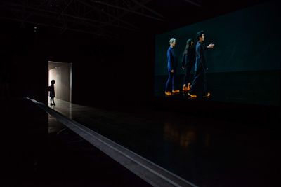 People walking in illuminated building