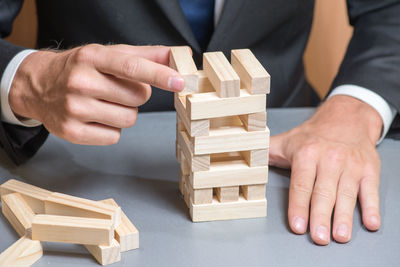 Close-up of man playing on table