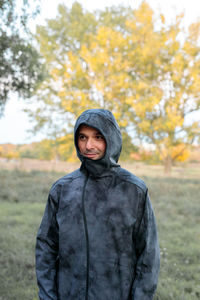 Portrait of smiling man standing on field