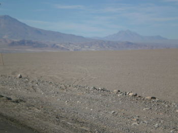 Scenic view of mountains against cloudy sky