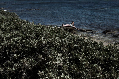 Man surfing on sea shore