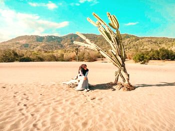 Man standing on sand dune in desert