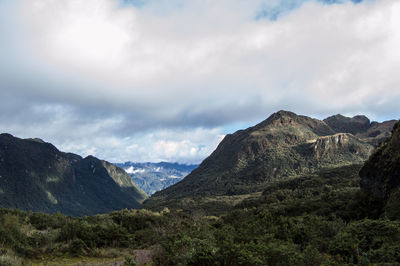 Scenic view of mountains against cloudy sky