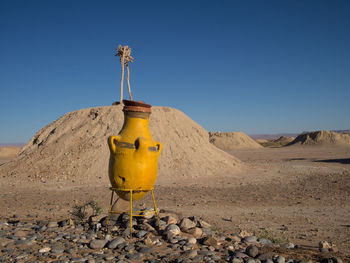 Yellow umbrella on desert