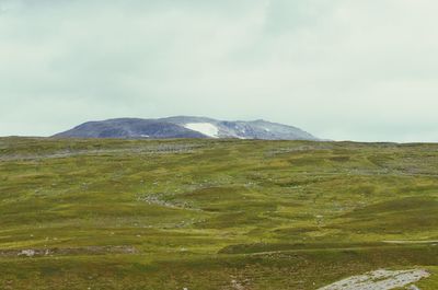 Scenic view of mountains against cloudy sky