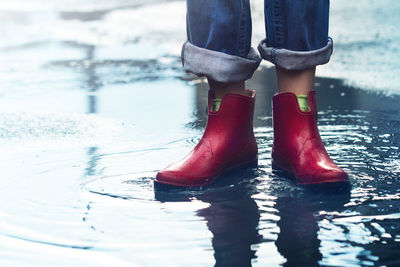 Low section of man standing in water