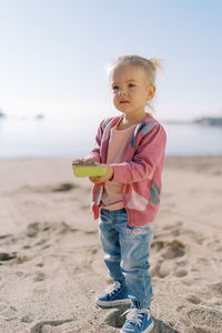 Portrait of boy standing at beach