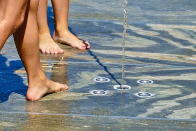 Low section of woman legs in water