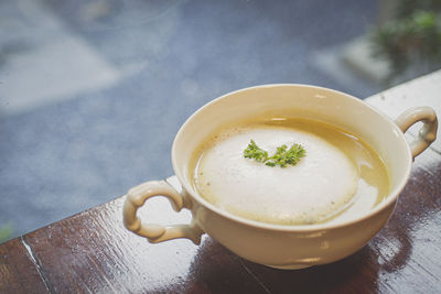 Mushroom soup in ceramic bowl breakfast meal healthy on the wooden table.