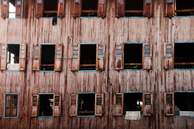 Full frame shot of open windows in wooden residential building