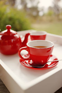 Close-up of tea cups in tray on table