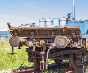 Locomotive on railroad track against sky