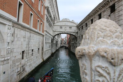 View of canal amidst buildings