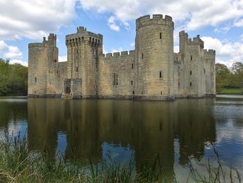 Reflection of fort on water against sky