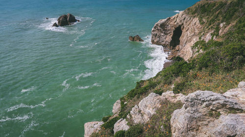 High angle view of rocks by sea