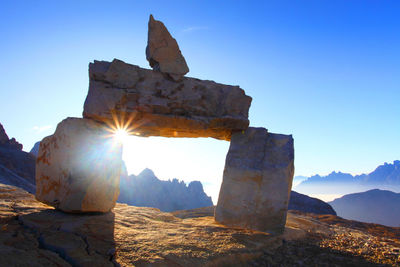 Rocks against clear blue sky during sunny day