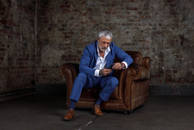 Portrait of young man sitting on chair