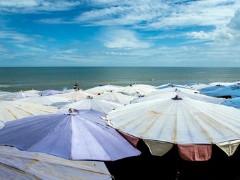 Large umbrellas crowded along the beach