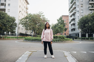 Young woman standing at city street