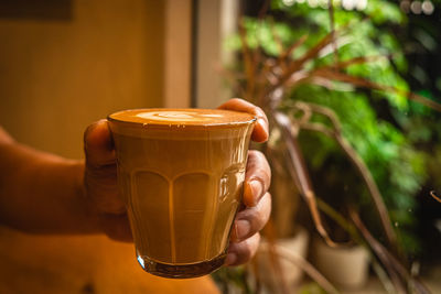 Midsection of woman holding coffee