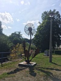 Statue of traditional windmill against sky