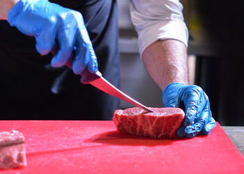 Midsection of man working on table