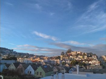 Houses in town against blue sky