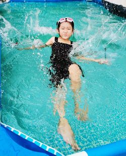 Full length of a girl swimming in pool