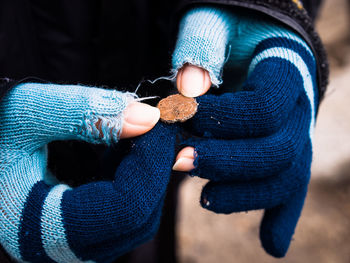 Midsection of woman holding penny