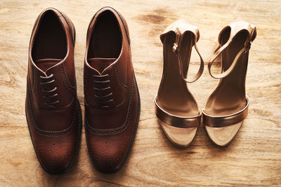 Low section of man wearing shoes on hardwood floor