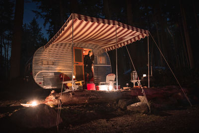 Man working on fire in field at night